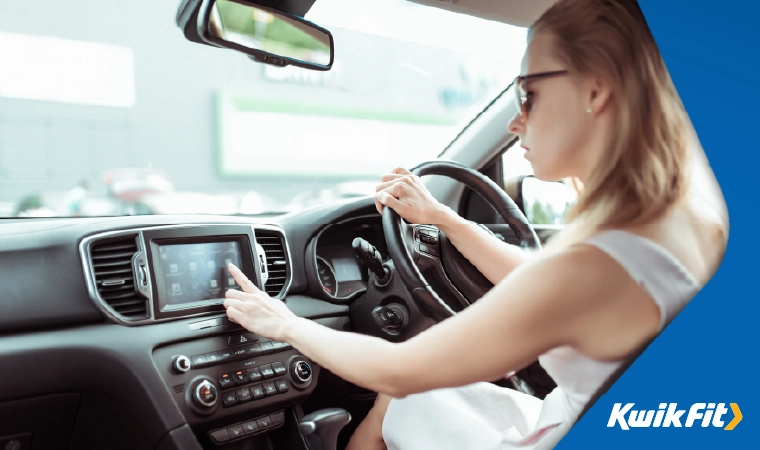 driver using the screen in their car dashboard